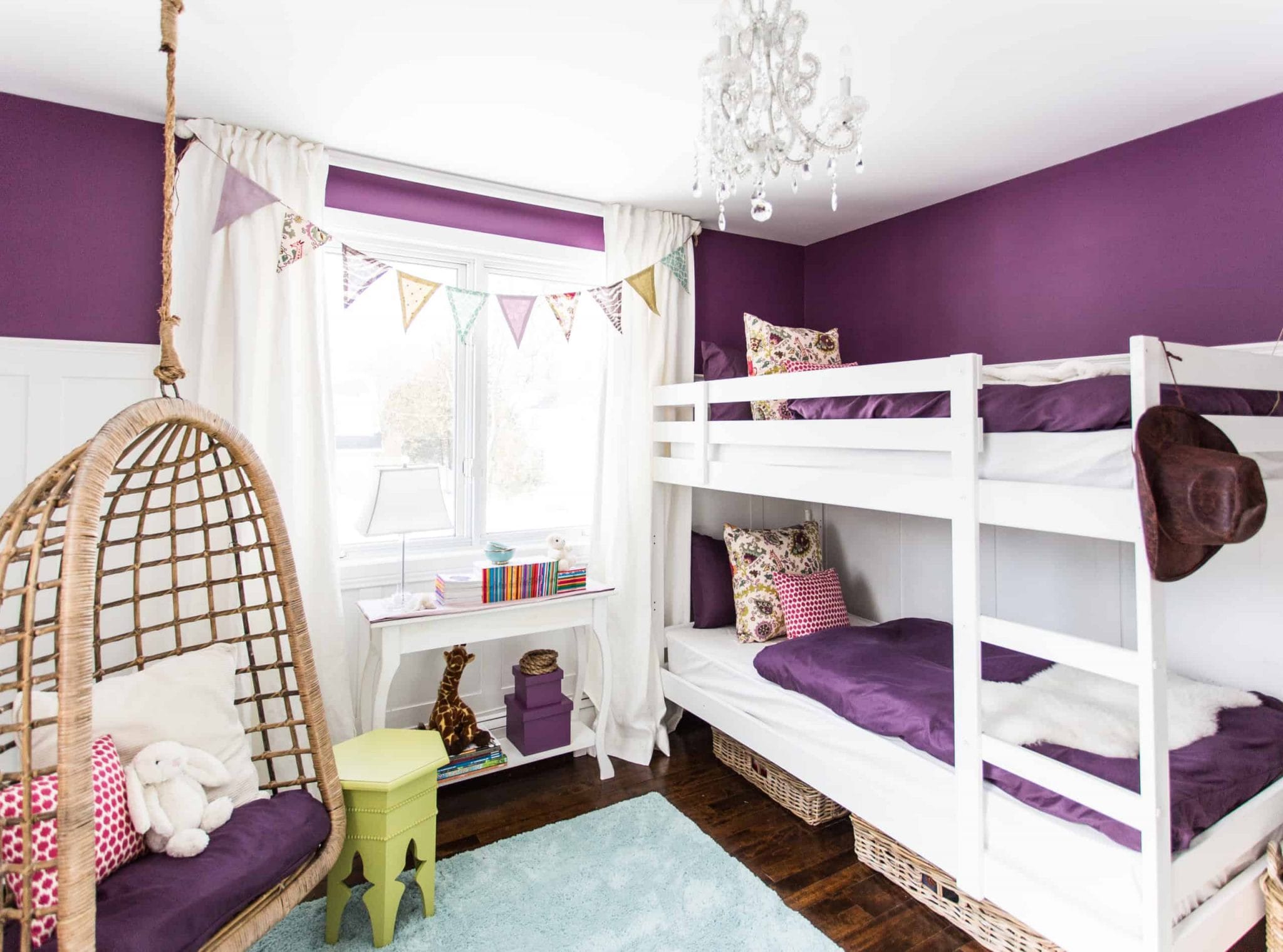White and purple bunk beds inside a purple themed bedroom