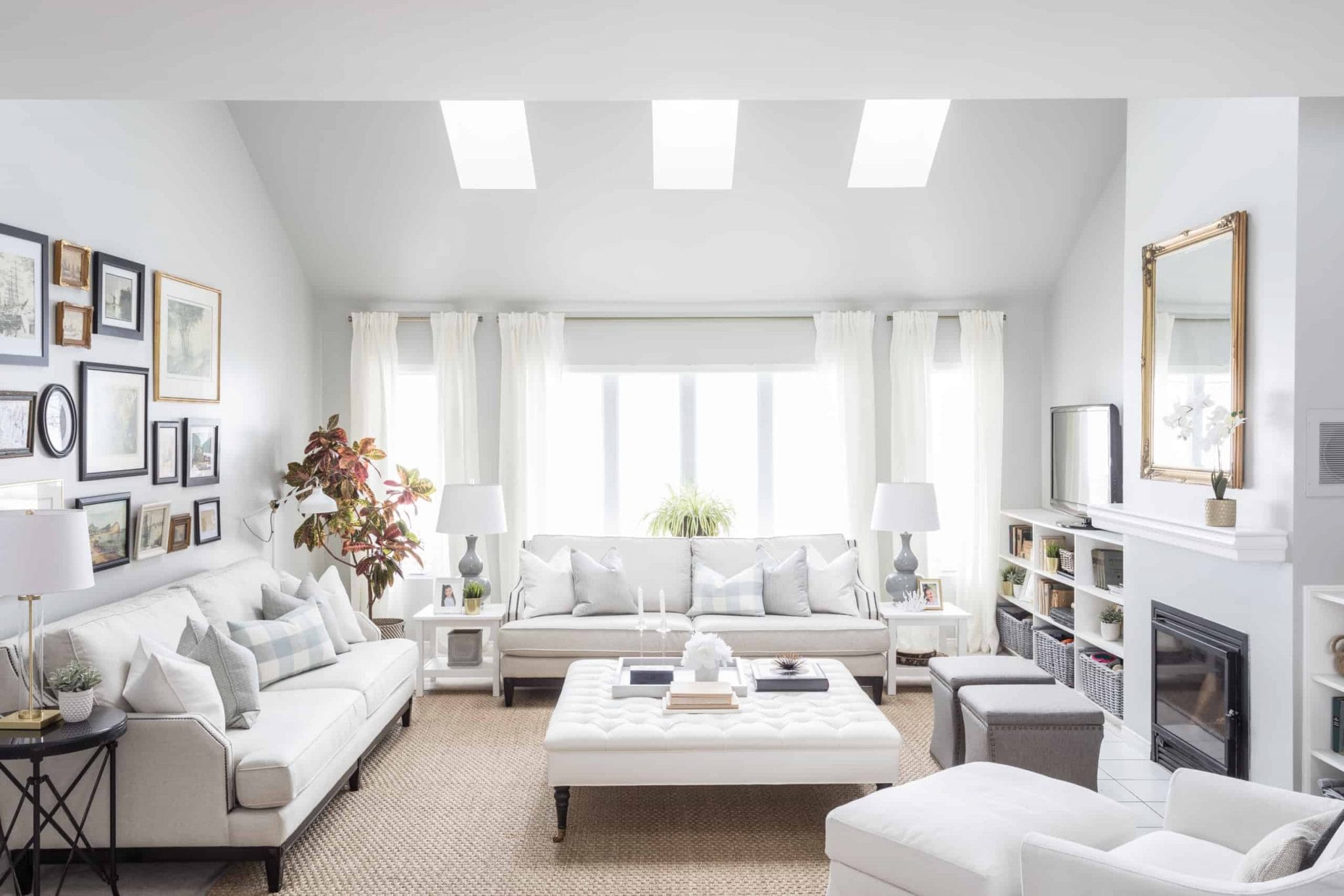 Bright, white living room with a large ottoman