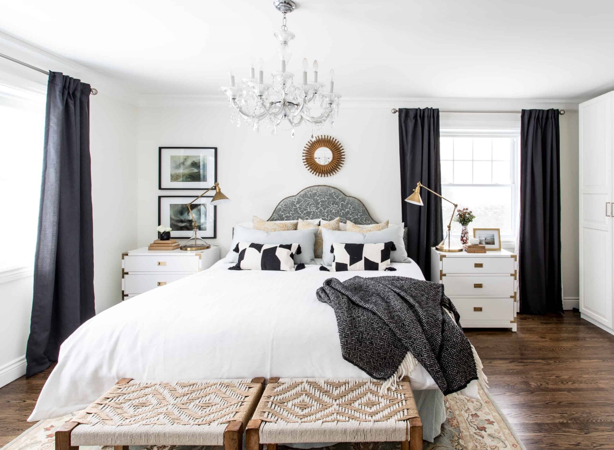 Large white bed within a black and white master bedroom