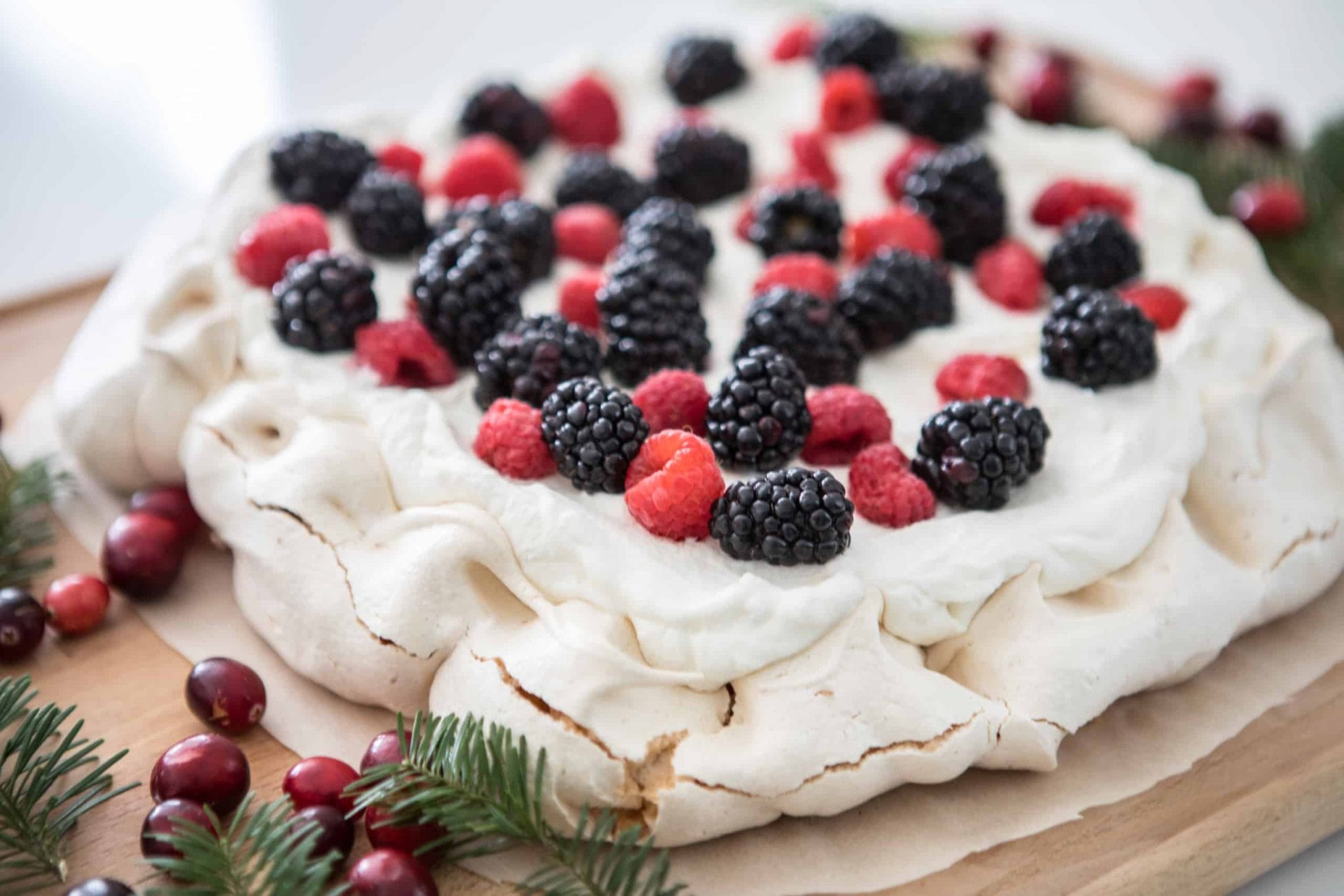 Razzberries and blackberry cake on a wooden plate