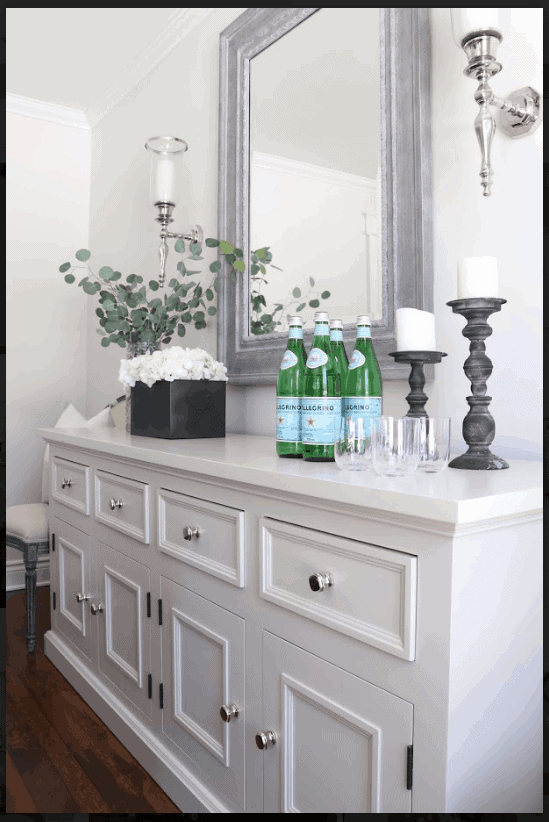 Large white dresser with drinks on it